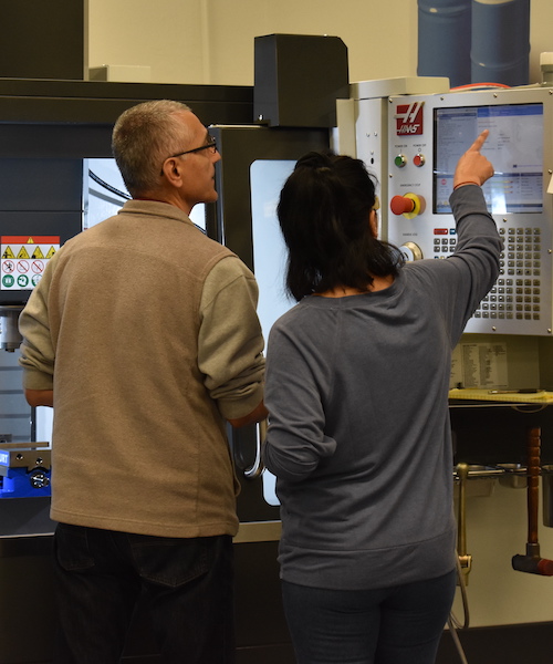 male teacher with female student at Haas machine